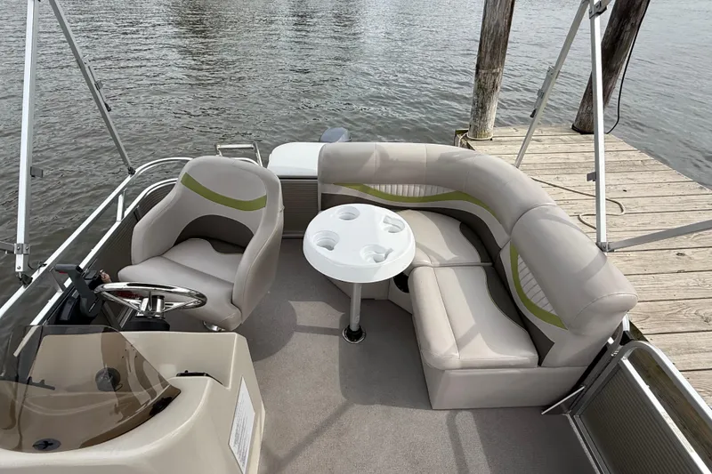Slide: The Image of 2016 Qwest Adventure 7514 Cruise Deluxe pontoon boat interior with seating and steering wheel. - 3