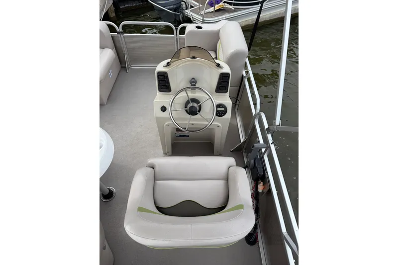 Slide: The Image of 2016 Qwest Adventure 7514 Cruise Deluxe boat helm with steering wheel and seating. - 7