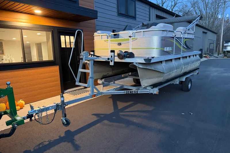 Slide: The Image of 2016 Qwest Adventure 7514 Cruise Deluxe pontoon boat on trailer near modern building. - 9