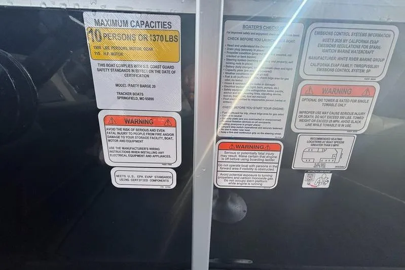 Slide: The Image of 2026 Sun Tracker Party Barge 20 DLX capacity and safety warning labels. - 4