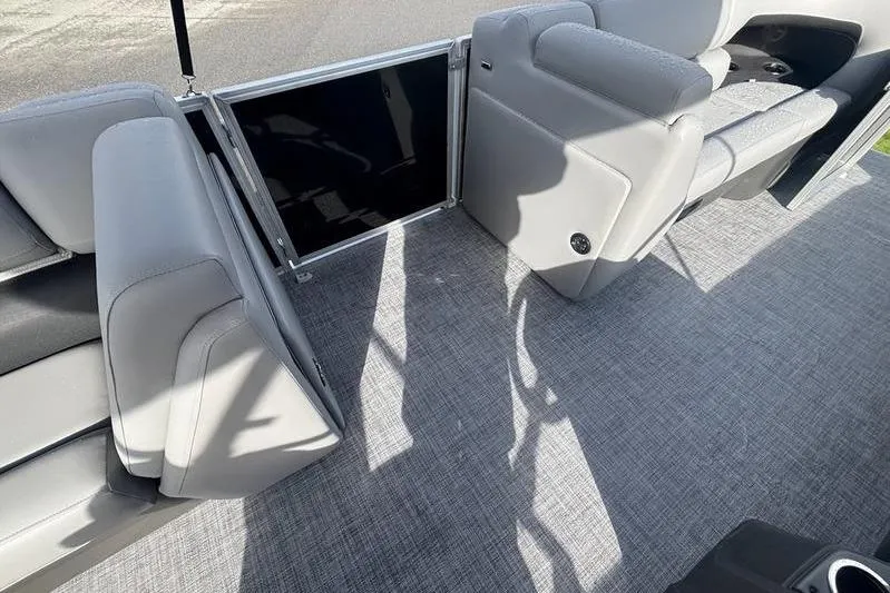 Slide: The Image of 2026 Sun Tracker Party Barge 20 DLX interior with gray seating and flooring. - 6