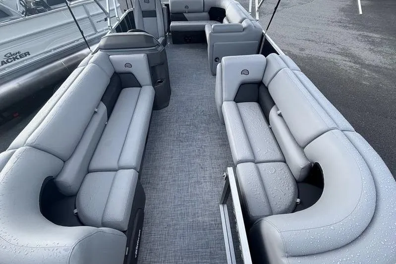 Slide: The Image of 2026 Sun Tracker Party Barge 20 DLX interior with gray seating and spacious layout. - 7