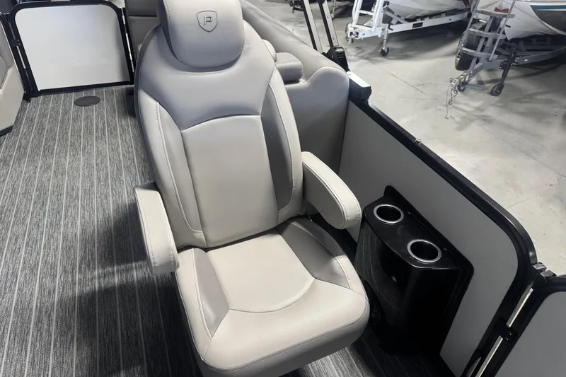 Slide: The Image of Premier 230 SunSation RF 2026 boat interior with plush captain's chair and cup holders. - 12