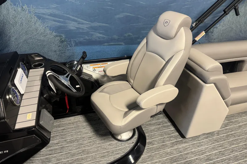 Slide: The Image of 2026 Premier 230 SunSation RF boat interior with captain's chair and steering console. - 13