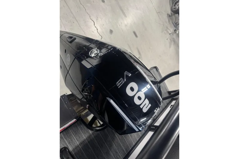 Slide: The Image of Outboard motor on 2026 Premier 230 SunSation RF boat, displayed indoors. - 17