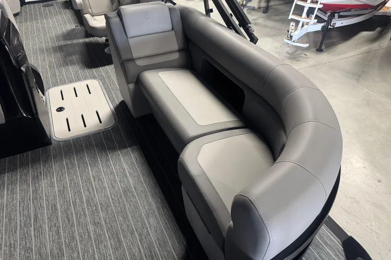 Slide: The Image of Luxurious seating on 2026 Premier 230 SunSation RF pontoon boat, featuring sleek gray upholstery. - 9