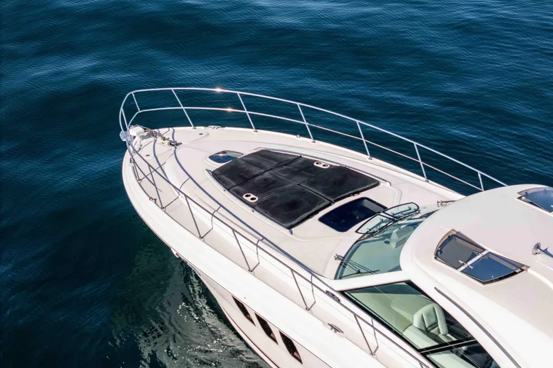 Slide: The Image of 2007 Sea Ray 48 Sundancer yacht cruising on calm blue waters. - 10