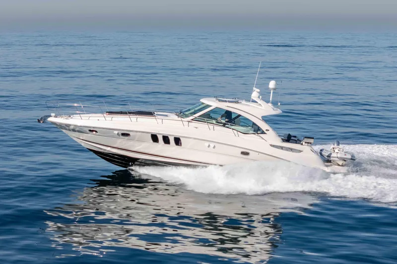Slide: The Image of 2007 Sea Ray 48 Sundancer yacht cruising on open water. - 12