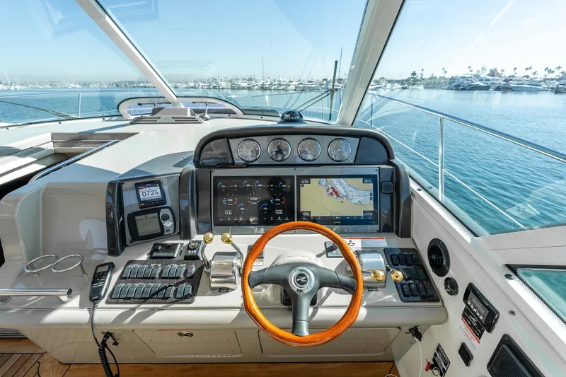 Slide: The Image of Helm of 2007 Sea Ray 48 Sundancer yacht with navigation screens and controls. - 21