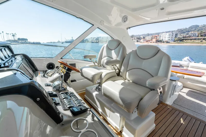 Slide: The Image of 2007 Sea Ray 48 Sundancer helm with luxurious seating and waterfront view. - 22