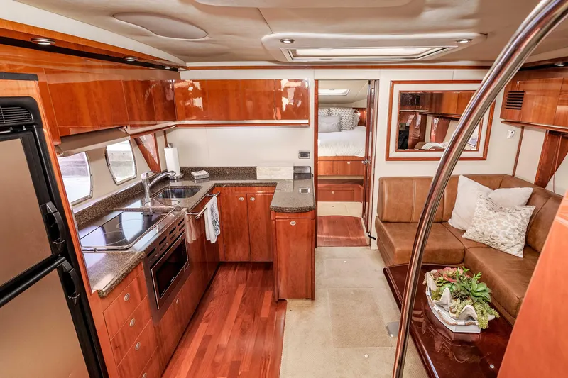 Slide: The Image of Luxurious 2007 Sea Ray 48 Sundancer yacht interior with modern kitchen and cozy seating area. - 24