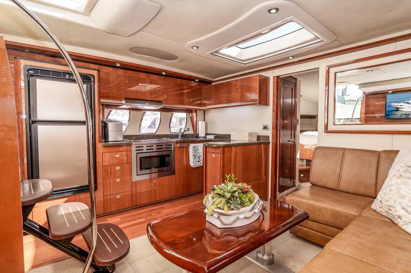Slide: The Image of Luxurious interior of 2007 Sea Ray 48 Sundancer yacht with modern kitchen and seating area. - 25