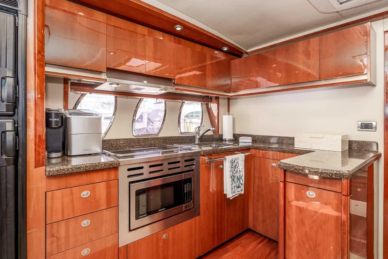 Slide: The Image of Luxurious 2007 Sea Ray 48 Sundancer yacht kitchen with modern appliances and wood cabinetry. - 27