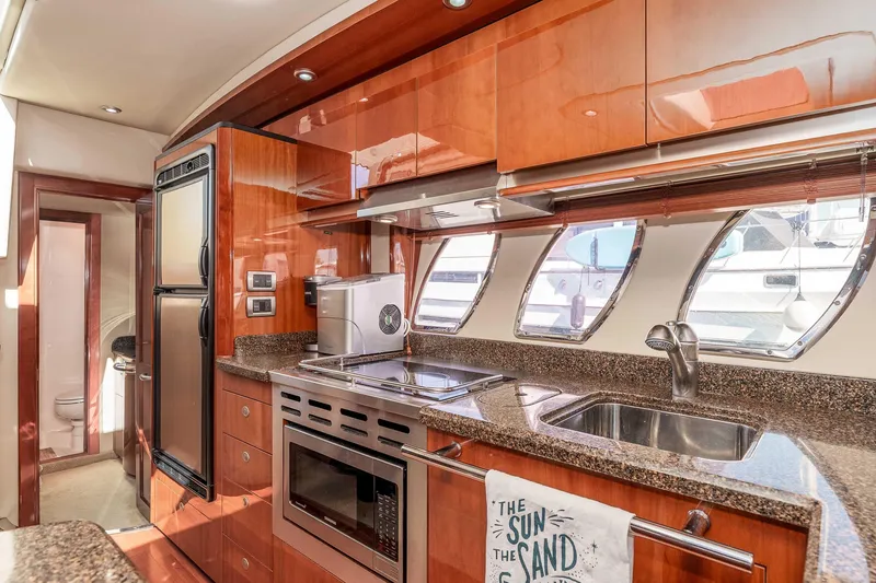 Slide: The Image of Luxurious 2007 Sea Ray 48 Sundancer yacht kitchen with modern appliances and sleek wood cabinetry. - 29