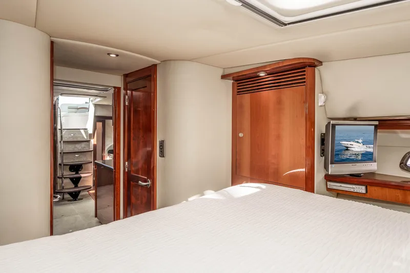 Slide: The Image of Interior of 2007 Sea Ray 48 Sundancer yacht with wood accents and TV. - 31
