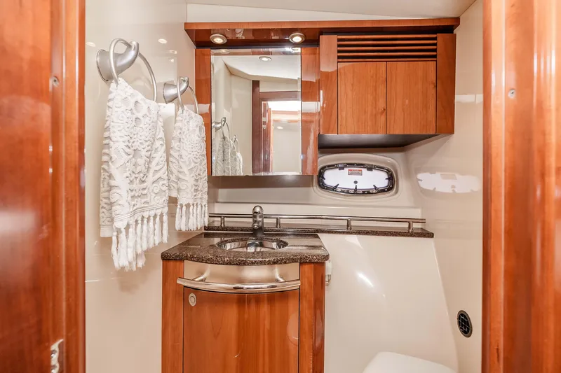 Slide: The Image of Luxurious 2007 Sea Ray 48 Sundancer yacht bathroom with wood cabinetry and elegant fixtures. - 35