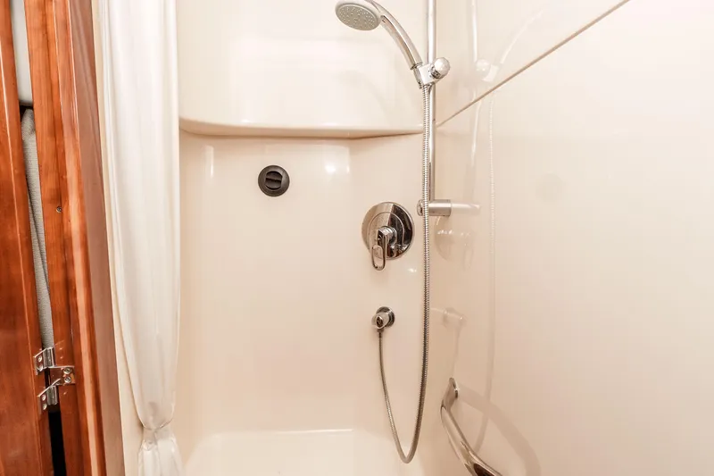 Slide: The Image of Shower area in 2007 Sea Ray 48 Sundancer yacht, featuring sleek fixtures and curtain. - 36