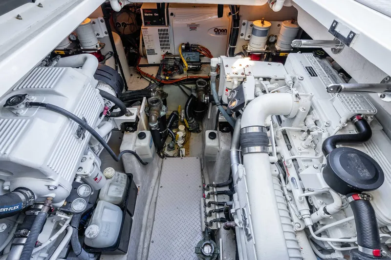 Slide: The Image of Engine room of 2007 Sea Ray 48 Sundancer yacht, showcasing dual engines and mechanical components. - 39