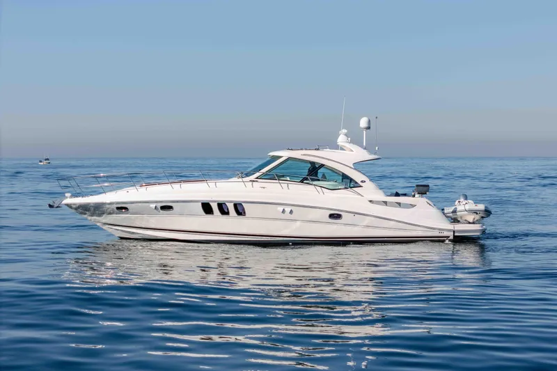 Slide: The Image of 2007 Sea Ray 48 Sundancer yacht cruising on calm blue waters. - 4