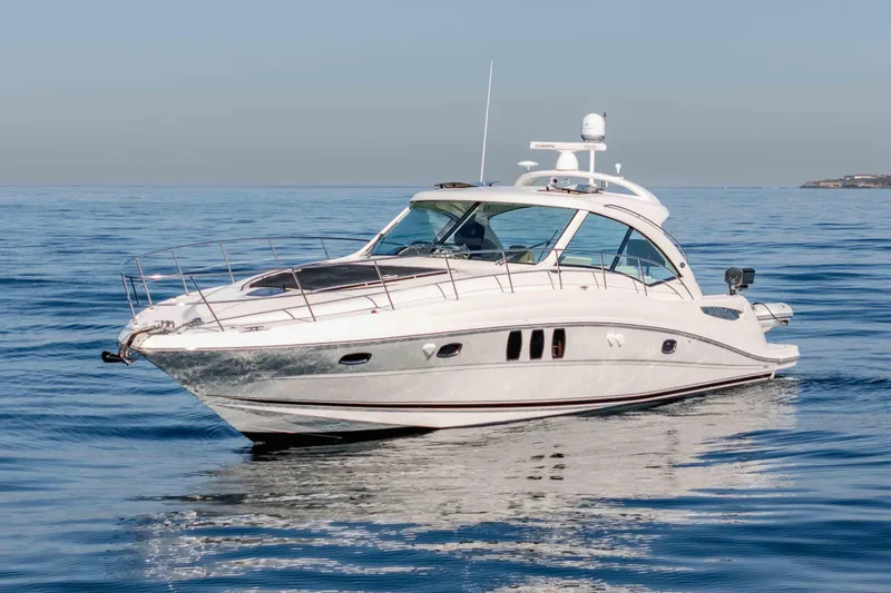 Slide: The Image of 2007 Sea Ray 48 Sundancer yacht cruising on calm ocean waters. - 5