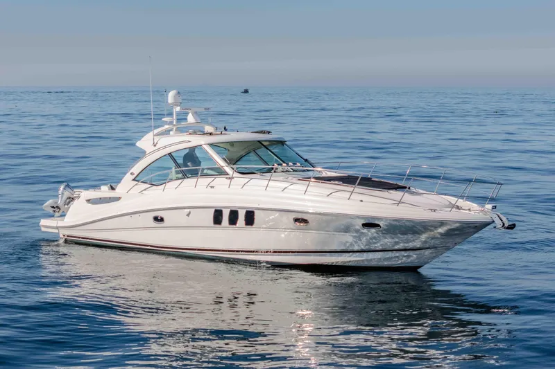 Slide: The Image of 2007 Sea Ray 48 Sundancer yacht cruising on calm blue waters. - 7