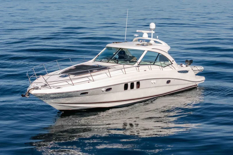 Slide: The Image of 2007 Sea Ray 48 Sundancer yacht cruising on calm blue waters. - 9