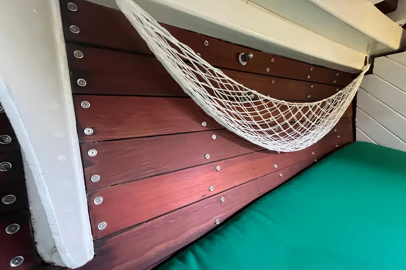 Slide: The Image of Interior of 1947 Murray Peterson Schooner with wooden paneling and netting. - 104