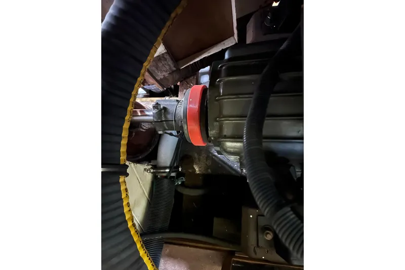 Slide: The Image of Engine compartment of 1947 Murray Peterson Schooner, featuring hoses and mechanical components. - 108