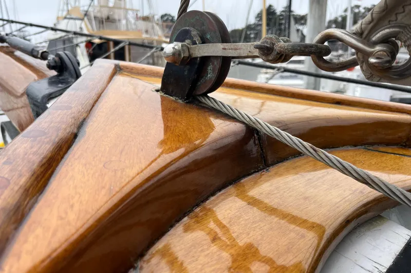 Slide: The Image of Close-up of 1947 Murray Peterson Schooner's polished wooden deck and rigging detail. - 111