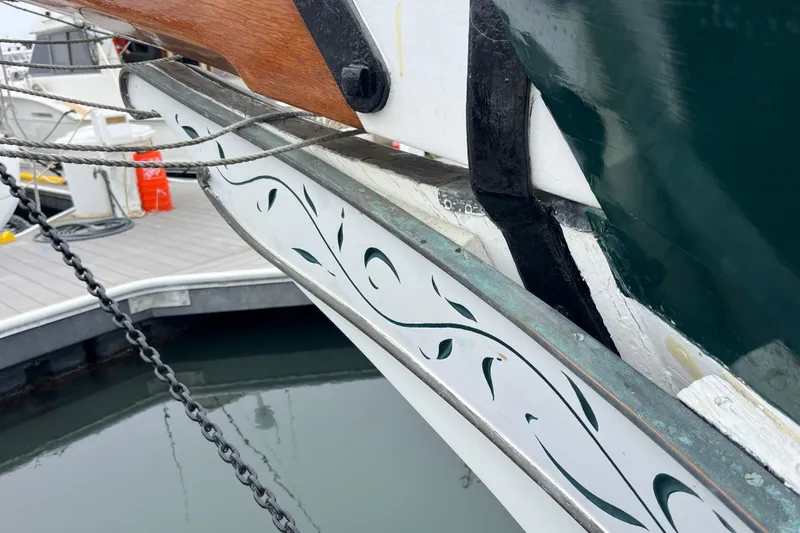 Slide: The Image of Close-up of 1947 Murray Peterson Schooner's decorative bow detail at dock. - 132