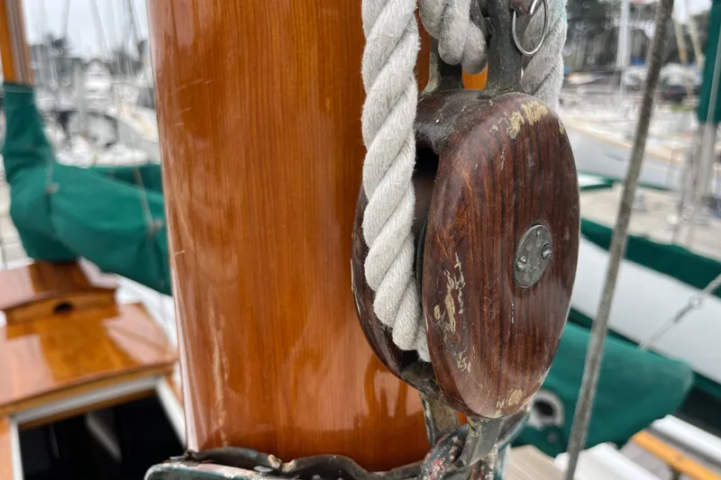 Slide: The Image of Close-up of a 1947 Murray Peterson Schooner's wooden pulley and rope detail. - 135