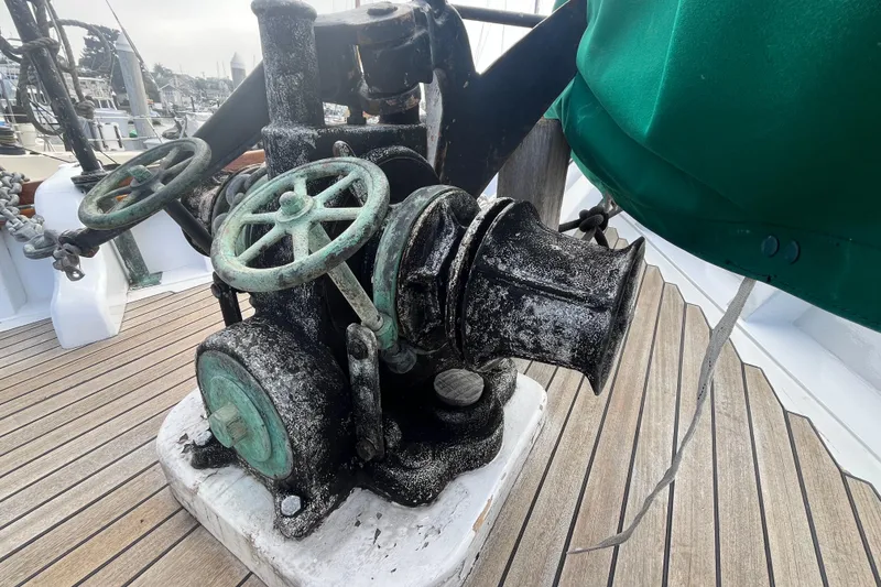 Slide: The Image of Vintage winch on 1947 Murray Peterson Schooner deck, showcasing nautical craftsmanship. - 14