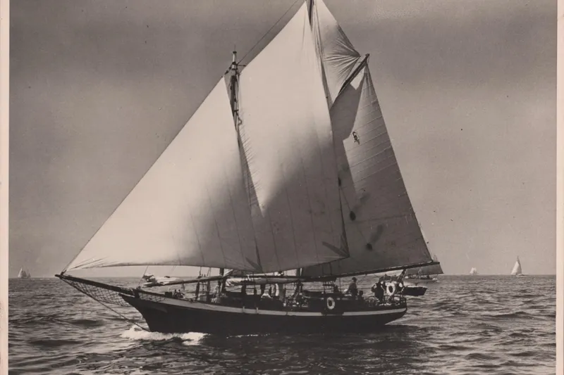 Slide: The Image of Vintage 1947 Peterson Schooner sailing on open sea with full sails. - 143