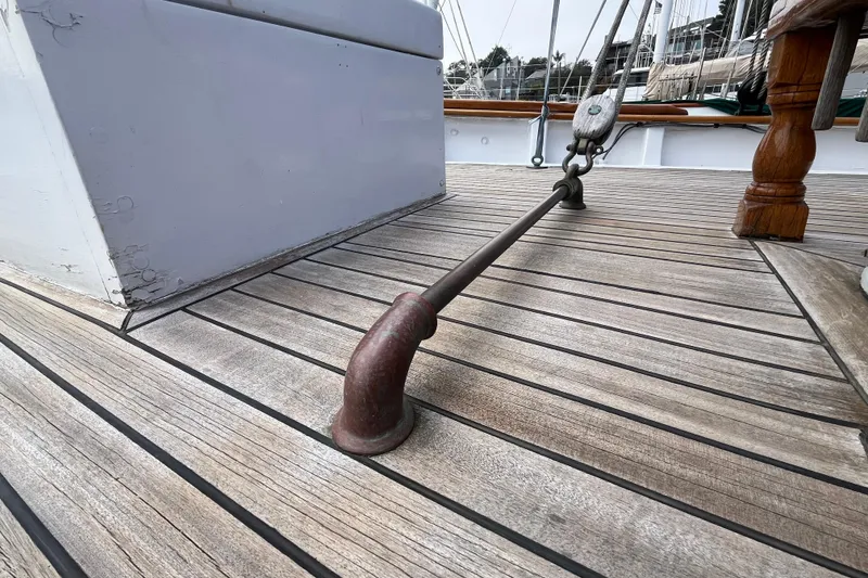 Slide: The Image of Deck of 1947 Murray Peterson Schooner with wooden planks and metal fittings. - 15