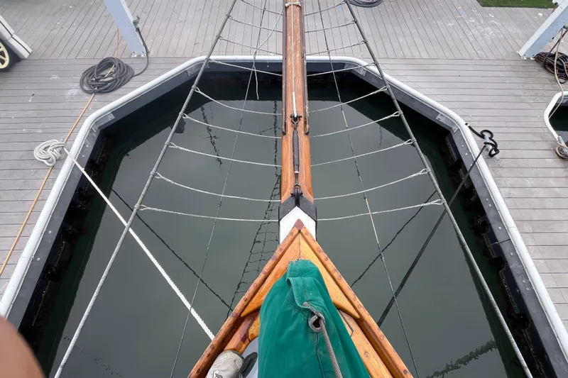 Slide: The Image of Bow view of 1947 Murray Peterson Schooner docked, showcasing deck and rigging. - 21