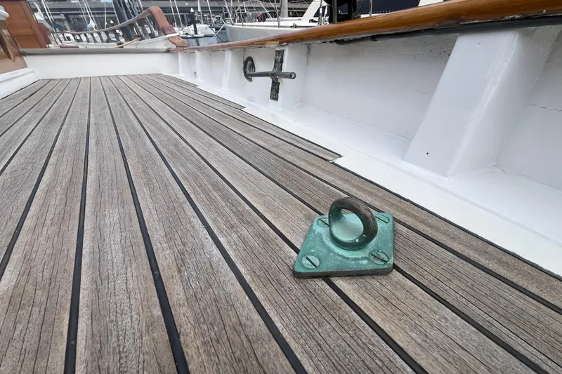 Slide: The Image of Wooden deck of 1947 Murray Peterson Schooner with metal fittings. - 26