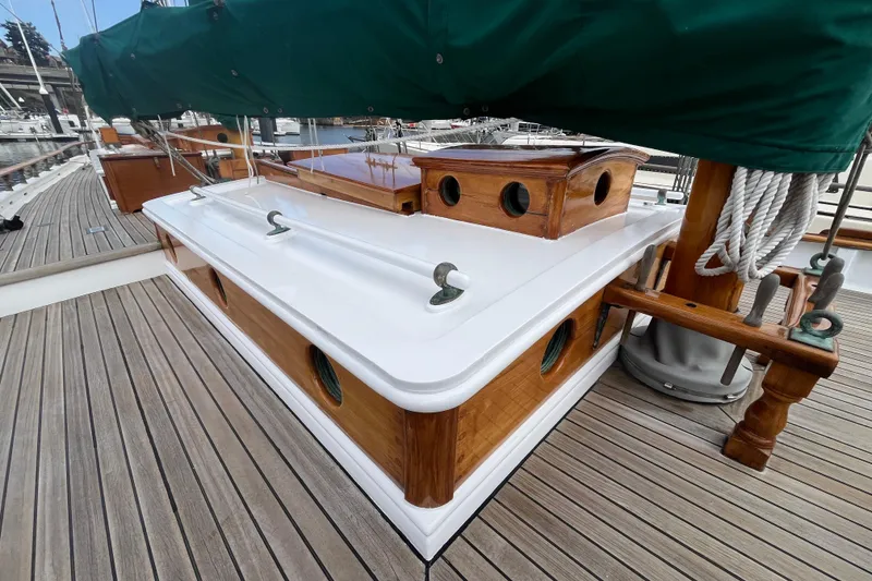 Slide: The Image of 1947 Murray Peterson Schooner deck with polished wood and green sail cover. - 27