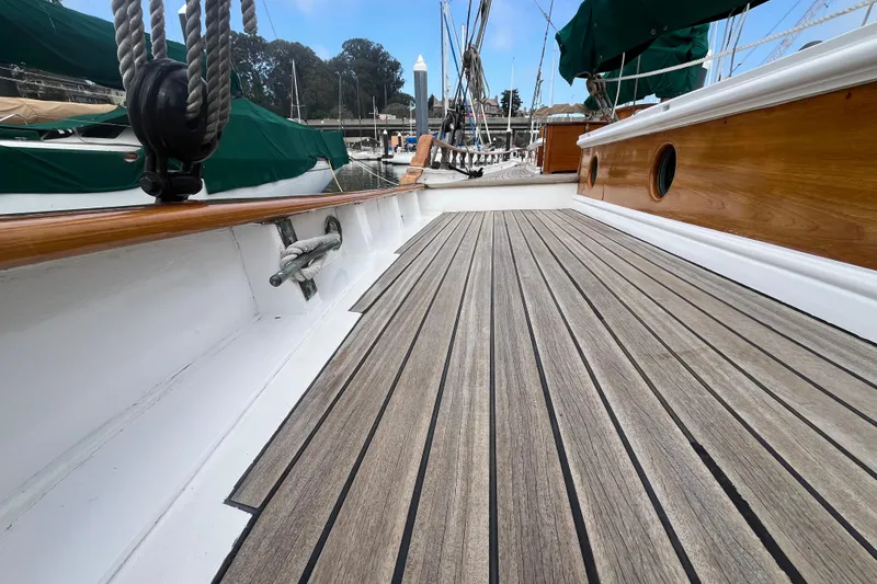 Slide: The Image of 1947 Murray Peterson Schooner deck with wooden finish and nautical details. - 28