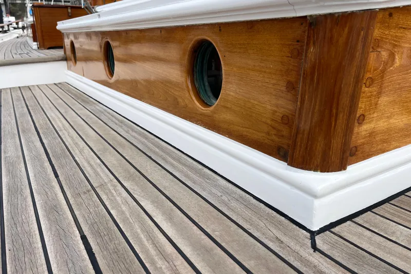 Slide: The Image of Wooden deck and portholes of a 1947 Murray Peterson Schooner. - 29