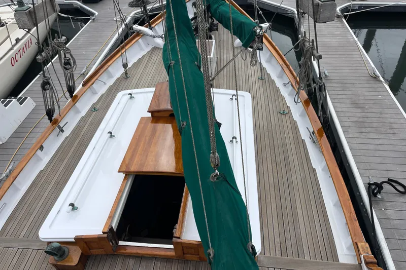 Slide: The Image of 1947 Murray Peterson Schooner deck with green sail cover at dock. - 32