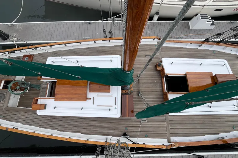 Slide: The Image of Top view of a 1947 Murray Peterson Schooner with wooden deck and green sails. - 33
