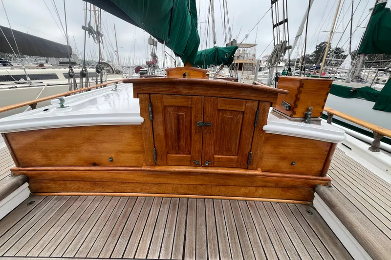 Slide: The Image of 1947 Murray Peterson Schooner with wooden deck and cabin, docked at marina. - 35