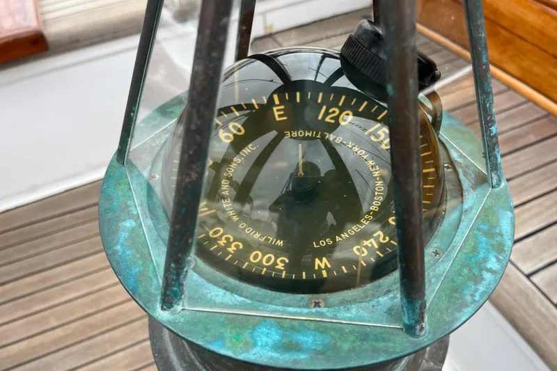 Slide: The Image of Vintage compass on 1947 Murray Peterson Schooner, showcasing nautical craftsmanship. - 37