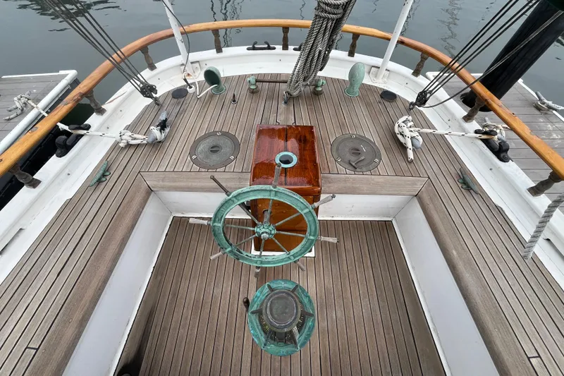 Slide: The Image of Wooden deck of a 1947 Murray Peterson Schooner with vintage steering wheel. - 39