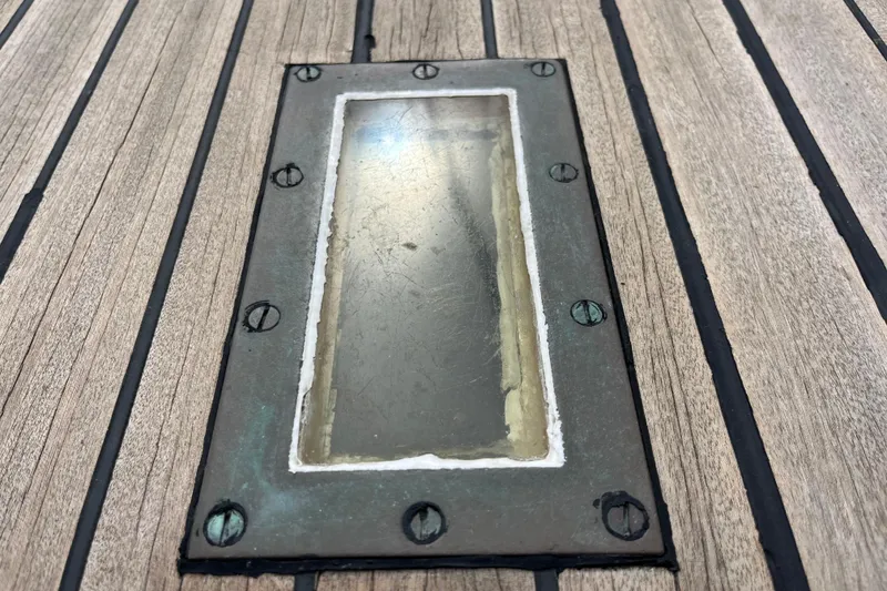 Slide: The Image of Close-up of a 1947 Murray Peterson Schooner deck detail with metal-framed glass panel. - 41