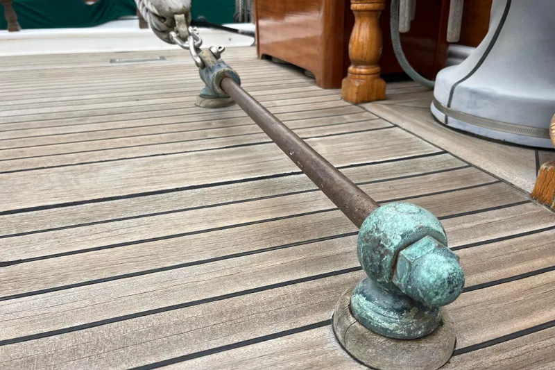 Slide: The Image of Close-up of a 1947 Murray Peterson Schooner deck with weathered metal fittings. - 43