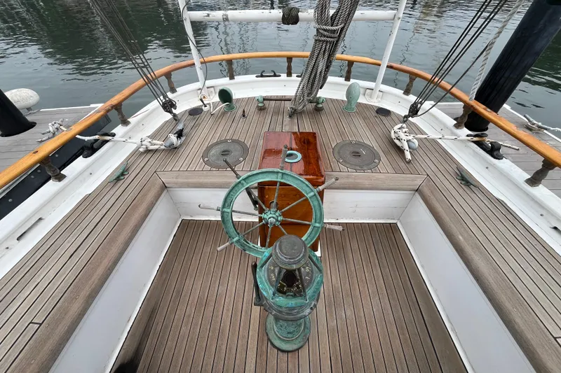 Slide: The Image of Vintage 1947 Murray Peterson Schooner deck with wooden wheel and nautical details. - 47