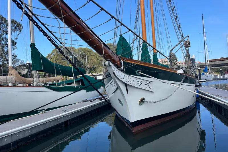 Slide: The Image of Vintage 1947 Murray Peterson Schooner docked in a serene marina setting. - 5