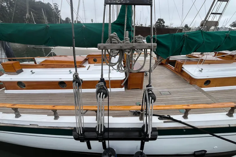 Slide: The Image of Vintage 1947 Murray Peterson Schooner with wooden deck and green sail covers. - 52