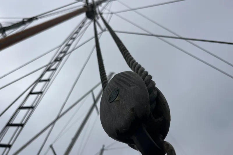 Slide: The Image of Ropes and rigging on a 1947 Murray Peterson Schooner against a cloudy sky. - 54